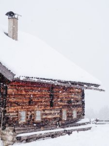 snow-covered house with a chimney	