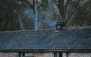 a house with smoke coming out of the chimney