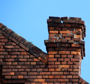 Gaps in the mortar and missing bricks on a chimney
