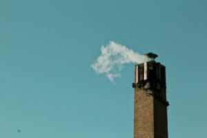 a chimney emitting excess smoke