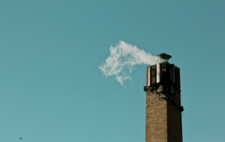 a chimney emitting excess smoke