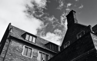 Grayscale photo of a house with chimney